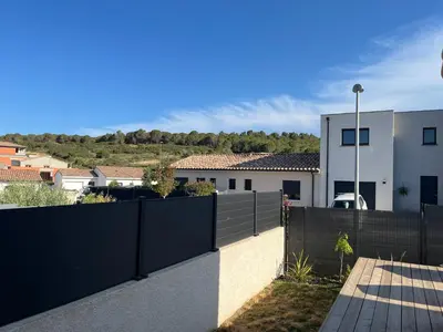 a fence in front of a house at Maison quartier la Campane Narbonne in Narbonne