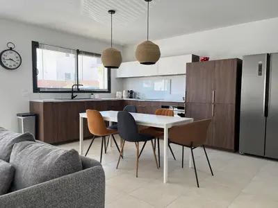 a kitchen and living room with a table and chairs at Maison quartier la Campane Narbonne in Narbonne