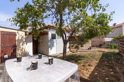 a picnic table in the backyard of a house at Ohm Sweet Home - Maison climatisée in Carcassonne