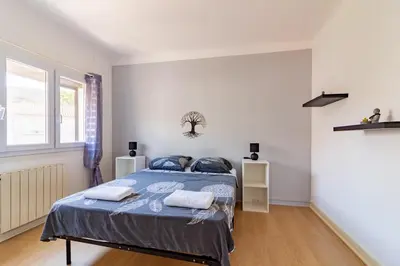 a bedroom with a bed with two towels on it at Ohm Sweet Home - Maison climatisée in Carcassonne
