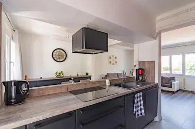 a kitchen with a sink and a counter top at Ohm Sweet Home - Maison climatisée in Carcassonne