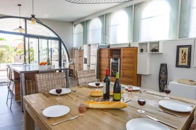 a dining room with a table with glasses of wine at Villa Saffron by Villa Plus in Villedaigne
