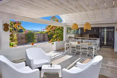 a living room with white chairs and a table at Villa Saffron by Villa Plus in Villedaigne