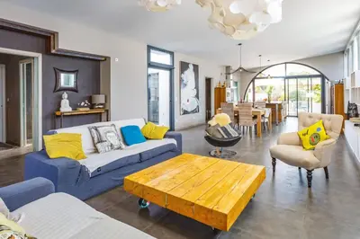 a living room with a blue couch and a table at Villa Saffron by Villa Plus in Villedaigne