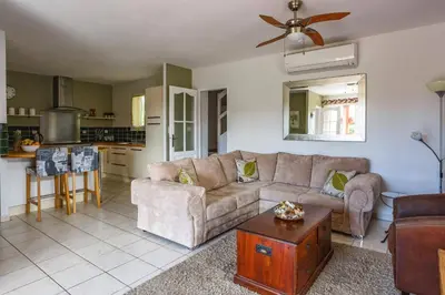 a living room with a couch and a table at Villa de lOrmeau by Villa Plus in Cambieure