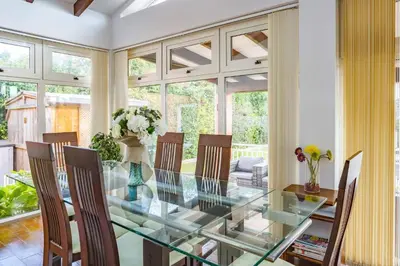 a dining room with a glass table and chairs at Villa de lOrmeau by Villa Plus in Cambieure