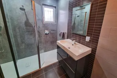a bathroom with a sink and a shower at Villa de lOrmeau by Villa Plus in Cambieure