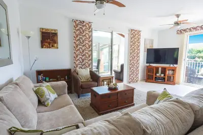 a living room with a couch and a tv at Villa de lOrmeau by Villa Plus in Cambieure