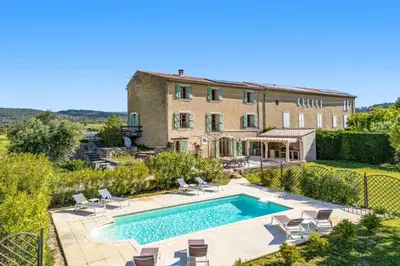 an external view of a house with a swimming pool at Villa Les Juliannes by Villa Plus in Azillanet