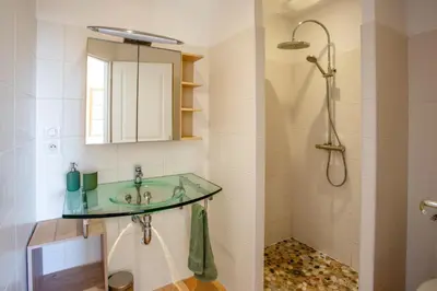 a bathroom with a sink and a shower at Villa Les Juliannes by Villa Plus in Azillanet
