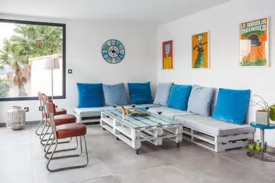 a living room with a couch and a table at Villa Terre des Vins by Villa Plus in Portel-des-Corbières
