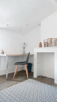 a bedroom with a bed and a desk and a chair at Le Pradel in Carcassonne
