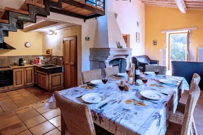 a dining room with a table and a kitchen at Villa Fraisse by Villa Plus in Fraissé-des-Corbières