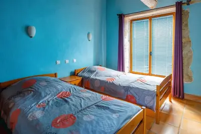 two beds in a room with blue walls and a window at Villa Fraisse by Villa Plus in Fraissé-des-Corbières
