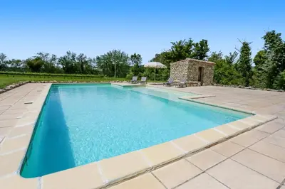 an image of a swimming pool in a backyard at Villa Domaine du Midi by Villa Plus in Capestang