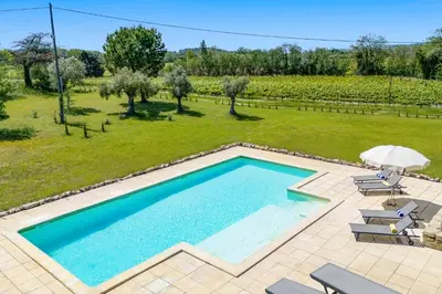 an image of a swimming pool in a yard at Villa Domaine du Midi by Villa Plus in Capestang