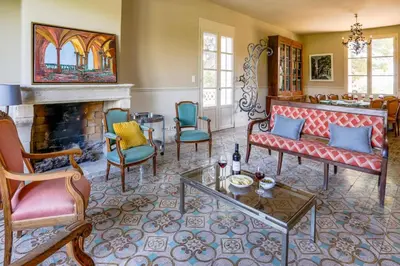 a living room filled with furniture and a fireplace at Villa Domaine du Midi by Villa Plus in Capestang