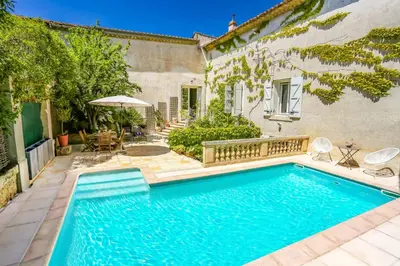 a swimming pool in the backyard of a house at Villa La Fontaine by Villa Plus in Capestang