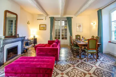 a living room with red furniture and a fireplace at Villa La Fontaine by Villa Plus in Capestang