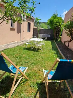 two chairs and a table in a yard at Logement - Carcassonne in Carcassonne