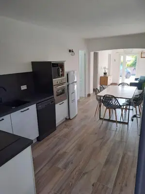 a kitchen and dining room with a table and a dining room at Logement - Carcassonne in Carcassonne