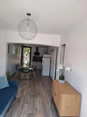 a living room with a blue couch and a table at Logement - Carcassonne in Carcassonne