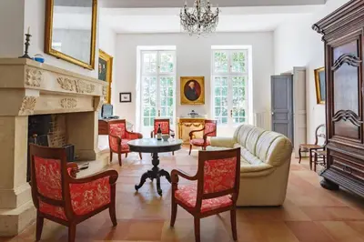 a living room with a couch and a fireplace at Villa Domaine Saint Roch by Villa Plus in Gaja-et-Villedieu