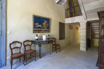 a room with chairs and a table with a painting on the wall at Villa Domaine Saint Roch by Villa Plus in Gaja-et-Villedieu