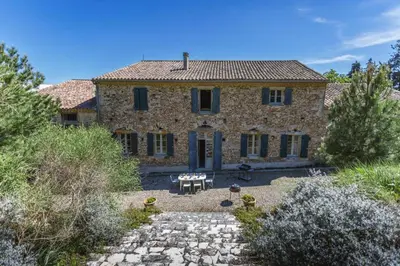 an external view of a large stone house at Villa Domaine Saint Roch by Villa Plus in Gaja-et-Villedieu