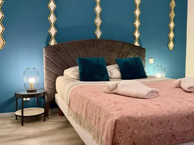 a bedroom with two beds with blue walls at La Bastide in Carcassonne