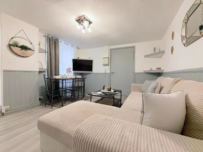a living room with a couch and a tv at La Bastide in Carcassonne