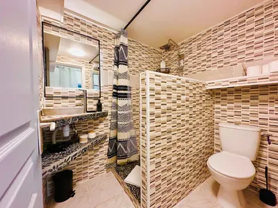 a bathroom with a toilet and a sink at La Bastide in Carcassonne