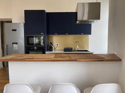 a kitchen with a counter with a sink and a microwave at Chez Pierrot - Pont-Neuf - Vue Cité Médiévale in Carcassonne