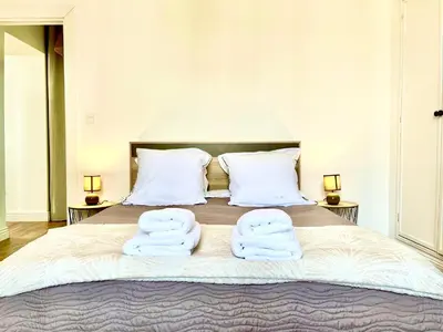 a bedroom with a bed with two towels on it at Chez Pierrot - Pont-Neuf - Vue Cité Médiévale in Carcassonne