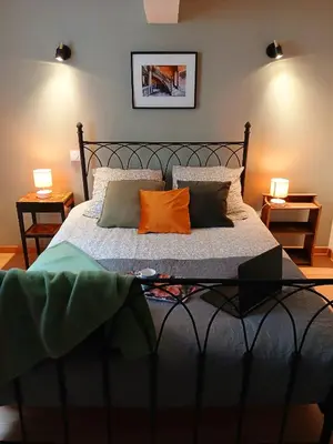 a bedroom with a bed with two pillows on it at 5bis in Quillan