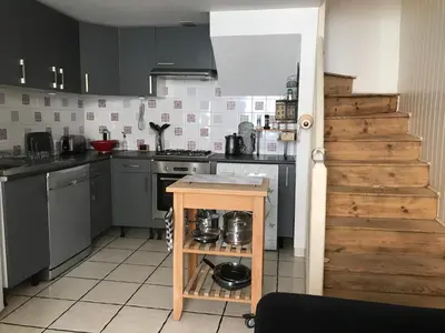 a kitchen with a small island in the middle at 5bis in Quillan