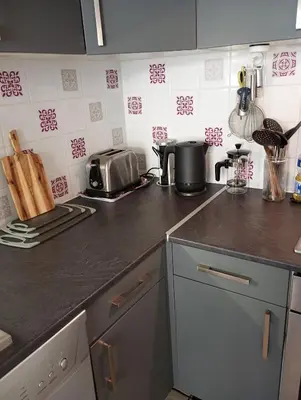 a kitchen with a counter top with a stove top at 5bis in Quillan
