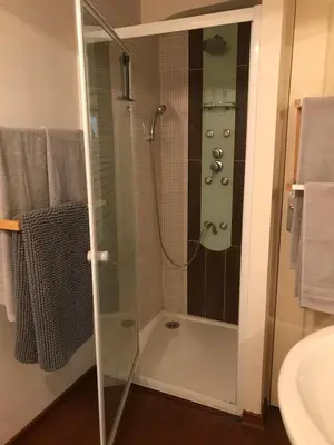 a bathroom with a shower with a glass door at 5bis in Quillan