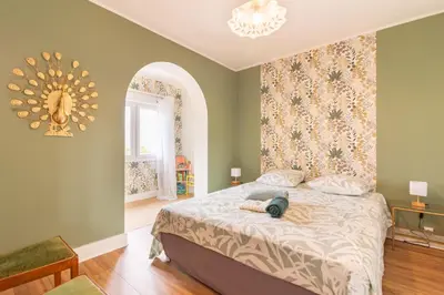 a bedroom with a large bed with a mirror on the wall at La Douce Occitane - Maison climatisée pour 6 in Carcassonne