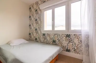 a bedroom with a bed and a window at La Douce Occitane - Maison climatisée pour 6 in Carcassonne