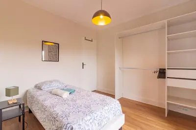a bedroom with a bed and a book shelf at La Douce Occitane - Maison climatisée pour 6 in Carcassonne
