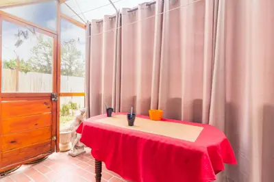 a room with a table with a red table cloth on it at La Douce Occitane - Maison climatisée pour 6 in Carcassonne