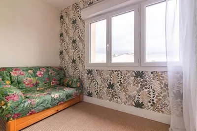 a living room with a couch and a window at La Douce Occitane - Maison climatisée pour 6 in Carcassonne