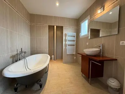 a bathroom with a large tub and a sink at Villa Les amandiers avec piscine in Saint-Laurent-de-la-Cabrerisse