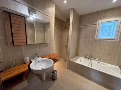 a bathroom with a sink and a bath tub and a sink at Villa Les amandiers avec piscine in Saint-Laurent-de-la-Cabrerisse