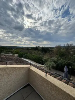a view from the balcony of a building with a cloudy sky at Villa Les amandiers avec piscine in Saint-Laurent-de-la-Cabrerisse