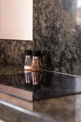 two glass jars sitting on top of a counter at Villa Terra Mera piscine privée proche de Narbonne in Cuxac-dʼAude