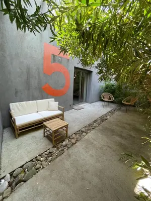 a building with a couch and a large number six at La Tuilerie du Bazalac in Trèbes