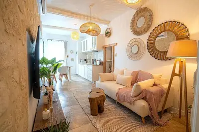 a living room with a couch and a table at Évasion scandinave à Narbonne élégance et confort réunis ! in Narbonne