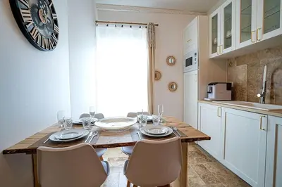 a kitchen with a wooden table with chairs and a dining room at Évasion scandinave à Narbonne élégance et confort réunis ! in Narbonne
